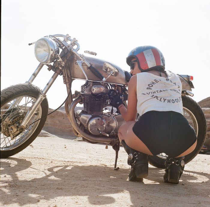 A playful frame from Girls on a motorcycle — online in Cairo